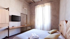 a bedroom with a bed with two towels on it at Folia in Rome