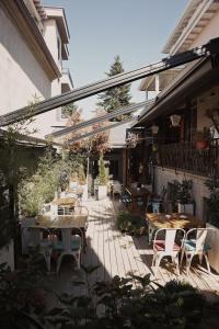 an outdoor patio with wooden tables and chairs at Meri Boutique Hotel in Korçë