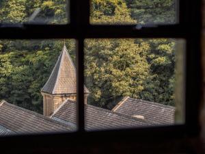 a view of a church from a window at Bowers Mill Aparthotel in Barkisland
