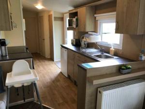 a kitchen with a sink and a counter top at Jubilee Lower Hyde Isle of Wight - Kingsgate 23 in Shanklin