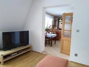 a living room with a flat screen tv sitting on a entertainment center at PENZION VLASTA in Zlín