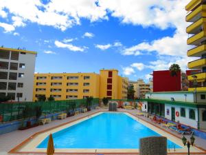 a large swimming pool in a city with buildings at Near the sea Las Arenas in Playa del Ingles