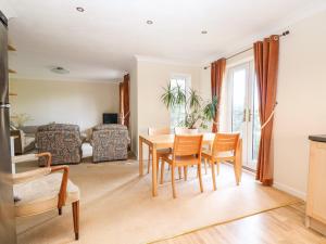 a living room with a table and chairs at 19 Quayside Walk in Southampton