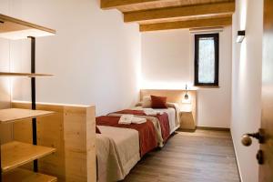 a small bedroom with a bed and a window at EL SERRADELL AGROTURISME in Sant Joan de les Abadesses +47 photos