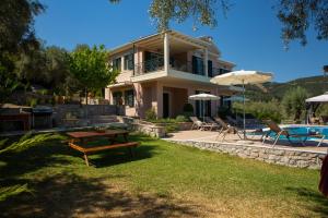 a house with a pool and a table and chairs at Villa Phaedra, Inoro Villas in Katouna