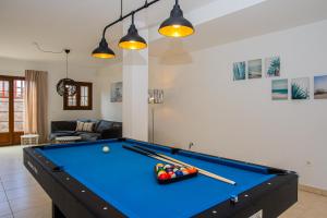 a living room with a pool table with balls and bats at Villa Amana 5 star luxury resort for 10 people in Playa Blanca in Playa Blanca