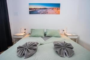 a bed with two bow pillows on top of it at Villa Amana 5 star luxury resort for 10 people in Playa Blanca in Playa Blanca +66 photos