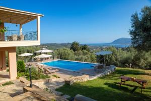 a villa with a swimming pool and a view of the ocean at Villa Phaedra, Inoro Villas in Katouna
