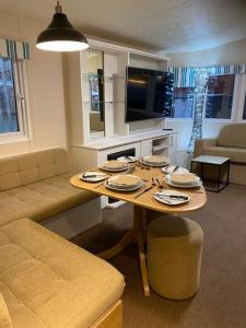 a living room with a table and a couch at The BALTIC LODGE NO2 3 BEDROOM AT CAINS BREWERY in Liverpool