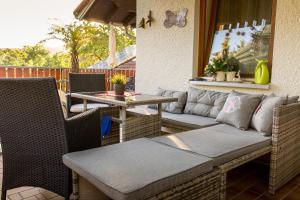 eine Terrasse mit einem Sofa und einem Tisch in der Unterkunft Frühstückspension Mayer-Schiller in Bernried