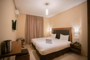 Uma cama ou camas num quarto em Hotel Etoile Du Nord