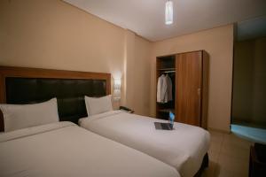 Uma cama ou camas num quarto em Hotel Etoile Du Nord