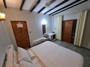 En eller flere senge i et værelse på Dhooni Finolhu Guesthouse