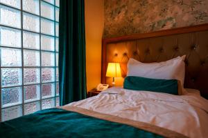 a bedroom with a bed next to a window at Capitol Hotel in Erbil