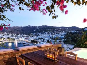 a balcony with a view of a harbor with white buildings at Patmos Eye Traditional Luxury Villas in Skala