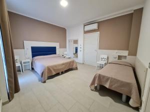 A bed or beds in a room at Hotel City 20
