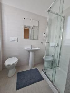 a bathroom with a toilet and a sink and a shower at hotel city 20 in Milan