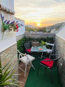un patio con tavolo e sedie sul balcone. di Apartamento Rural La Bandolera a El Bosque