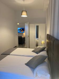 Postel nebo postele na pokoji v ubytování Apartamentos La Aldea Suites