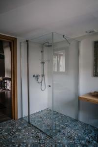 a glass shower stall in a room at Apartament nad Potokiem in Witów