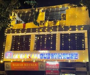 a yellow building with lights on top of it at Shree Mahakali Guest House & Dormitory in Ahmedabad