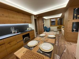 a kitchen with a table with plates on it at Chalet Lilla Livigno in Livigno