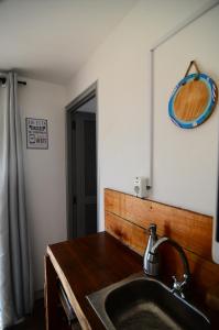 a bathroom with a sink and a mirror at Geo in Punta Del Diablo +54 photos