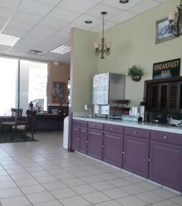 a fast food restaurant with purple cabinets and a counter at OK Hotel in Oklahoma City