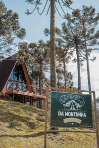 a sign in front of a building with a tree at URUBICI - Cabana da Montanha in Mundo Novo