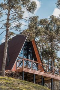 a cabin in the woods with a wooden roof at URUBICI - Cabana da Montanha in Mundo Novo