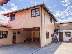 a large house with a garage and a staircase at Casa família bonfim in Urubici
