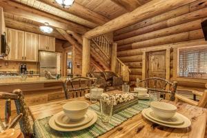 a dining room and kitchen in a log cabin at Sonshine By The Stream, Next To A Stream, 560 FREE tickets each paid day in Cosby