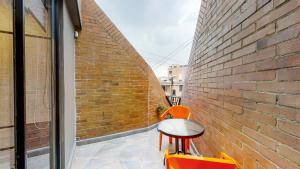 a balcony with a table and chairs next to a brick wall at Terrazas in Bogotá