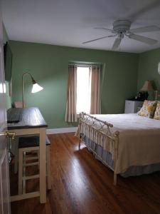 a bedroom with a bed and a table and a window at Tandem Bike Inn in Belmar
