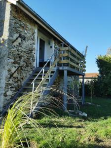 a set of stairs outside of a stone house at La bulle suspendue in Bassevelle +11 photos