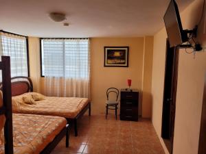 Ένα ή περισσότερα κρεβάτια σε δωμάτιο στο Hostal Haziel