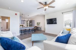 a living room with a couch and a ceiling fan at Beach Town Home - Walk to Beaches Downtown Activities and so much more in Half Moon Bay