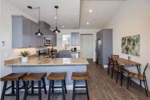 a kitchen with a large island with bar stools at Beach Town Home - Walk to Beaches Downtown Activities and so much more in Half Moon Bay