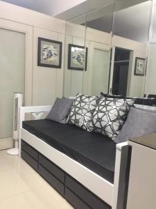 a bedroom with a bed with a large mirror at Sea Residences MoA Manila in Manila