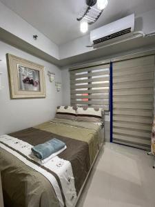 a bedroom with two beds and a air conditioner at Sea Residences MoA Manila in Manila