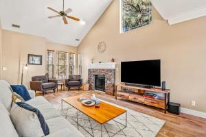 a living room with a fireplace and a tv at Whispering Pines in Flagstaff