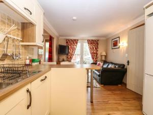 a kitchen with a table and a couch in a room at Annexe in Norwich