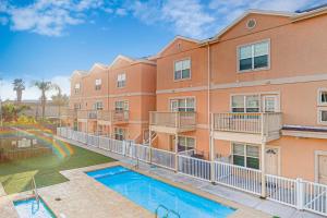 an apartment building with a pool in front of it at Star Beach Side Condominiums #105 in South Padre Island