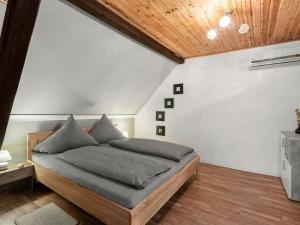 a bedroom with a large bed with a wooden ceiling at Serene Holiday Home in Nehren with a beautiful Garden in Nehren