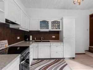 a kitchen with white cabinets and a sink at Serene Holiday Home in Nehren with a beautiful Garden in Nehren