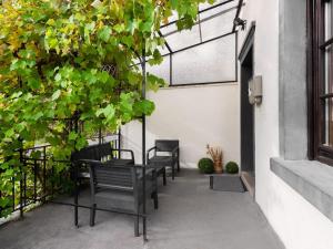 a patio with benches and plants and a window at Serene Holiday Home in Nehren with a beautiful Garden in Nehren