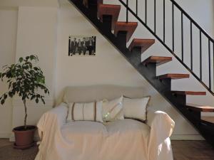 a white couch in a living room under a staircase at Soleado MDP in Mar del Plata