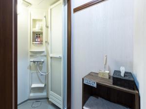 a bathroom with a shower and a sink and a mirror at Woman Only Guesthouse Nanohana (Female only) in Kyoto