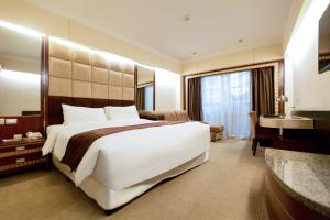 Postel nebo postele na pokoji v ubytování Nanjing Central Hotel