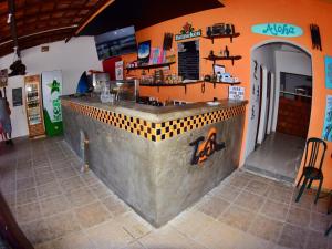 a fast food restaurant with a counter in a room at Pousada Praia do Tombo in Guarujá